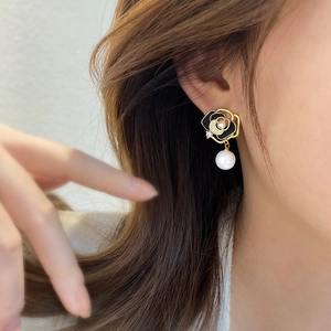 Elegant vintage camellia drop earrings with black enamel, pearls, and gold finish