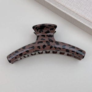 Detail view of the elegant leopard print hair claw clip on a neutral background