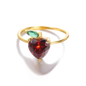 Detailed view of apple-shaped ring with red heart zircon and green marquise leaf