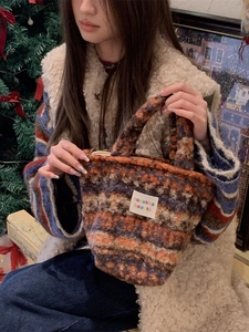 Colorful striped plush knit handbag featuring textured fabric and retro casual style