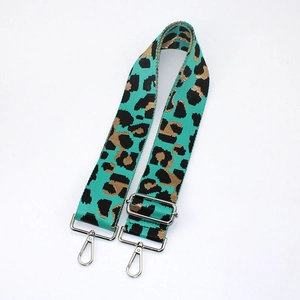 Detail of adjustable leopard print bag strap in blue and gold with silver metal hooks
