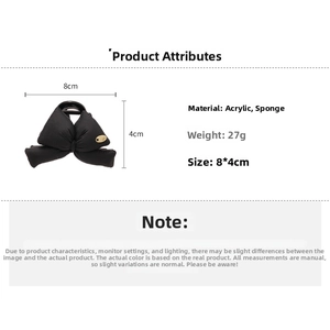 Detail view of a black sponge bow hair claw clip made of acrylic and soft fabric