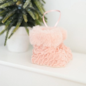 Detailed view of pink plush Christmas boot ornament with knit texture and hanging ribbon