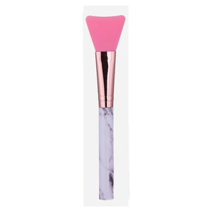 Detail of pink silicone mask brush featuring a rose gold ferrule and marble pattern handle