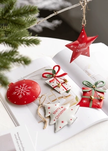 Macro view of Nordic Christmas metal ornaments including stars and gift boxes on festive background