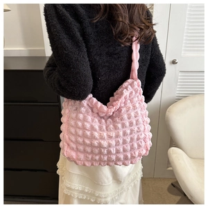 Detail view of pink bubble texture fabric on a large capacity shoulder tote bag