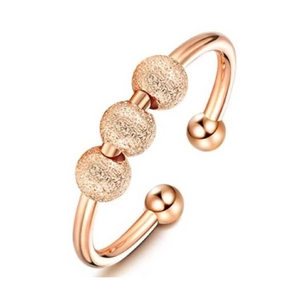 Minimalist rose gold anxiety ring with three rotating frosted beads and open band design