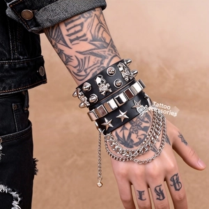 Detail view of multi-layer punk leather bracelets with silver skull and rivet accents
