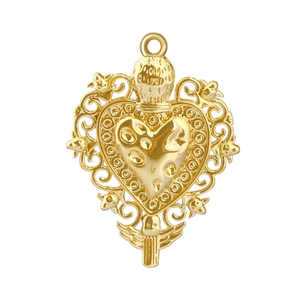 Detailed view of vintage gold-plated heart pendant with ornate filigree and crown motifs