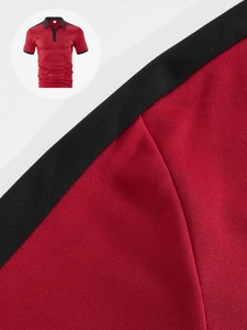 Close-up of red and black patchwork knit fabric texture on men's short sleeve polo shirt
