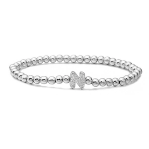 Detail of silver beaded stretch bracelet featuring a pave zircon letter N charm