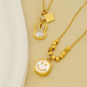 Detail of golden stainless steel necklaces with shell rabbit and lucky character charms