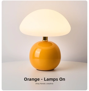 Detail of creative mushroom lamp showing glossy orange base and soft glowing frosted shade