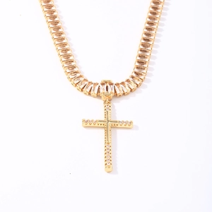 Minimalist gold cross necklace for women with sparkling cubic zirconia on white background