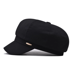 Classic black cotton newsboy cap with vintage octagonal design and metal logo plate