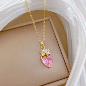 Macro shot of crown necklace with pink heart gemstone and sparkling cubic zirconia details