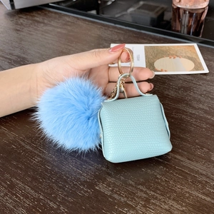 Mini handbag keychain with mint green faux leather, blue fur pom and gold hardware