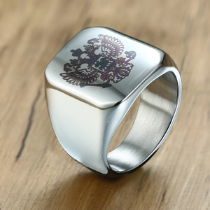 Close-up of silver square signet ring with engraved double-headed eagle emblem
