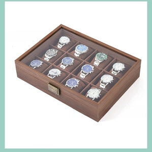 Detailed top view of 12-slot wood watch box with glass window and metal lock