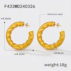 Detail view of gold-plated titanium steel twist hoop earrings with size specifications