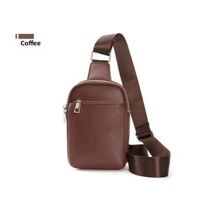 Detail of coffee brown lychee grain leather sling bag with silver zipper and nylon strap