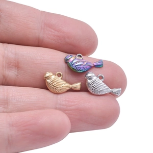 Three bird shaped stainless steel pendants in gold, silver and iridescent finishes