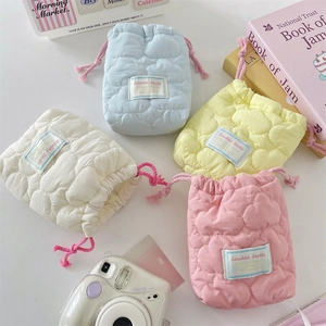 Quilted cotton drawstring camera pouches in pastel pink, blue, yellow, and white colors