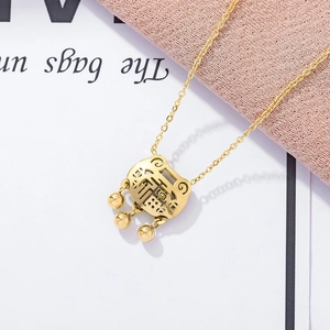 Macro shot of 18K rose gold plated Fu lock pendant with bells on white paper background