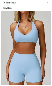 Front view of model wearing sky blue V-neck sports bra and high-waist fitness shorts