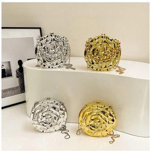 Detailed macro view of 3D rose petal textures on gold and silver acrylic evening bags