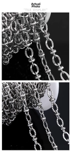 Macro shot of silver embossed stainless steel oval chain links with textured finish