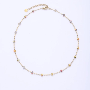 Detailed shot of gold plated chain necklace featuring colorful faceted beads and square spacers