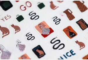 Macro detail of ultra-thin 5D graffiti nail art stickers with vintage retro illustrations