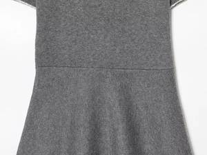 Detailed view of grey knit dress waistline with fine stitching and soft fabric texture