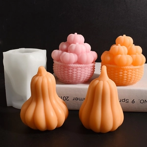 Macro shot of pumpkin-shaped silicone mold and DIY aroma candles on dark background