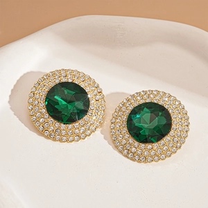 Macro detail of vintage emerald green round earrings with halo rhinestone borders