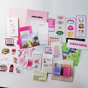 Flat lay macro of pink macaron-style stationery stickers and aesthetic greeting cards