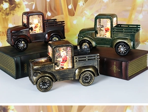 Close-up of vintage Christmas truck lanterns with LED lights and swirling glitter