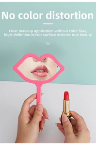 Pink lip-shaped handheld makeup mirror with handle shown in a realistic use scenario
