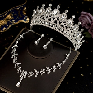 Detailed view of silver bridal jewelry set with sparkling rhinestones on black stand
