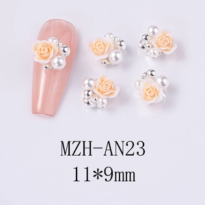 Detailed view of 11x9mm pink resin rose nail charms with pearls and silver beads