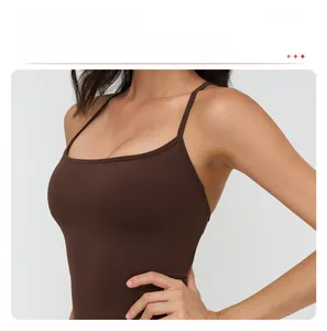 Detail view of the slim straps and square neckline on the dark brown yoga sports bra
