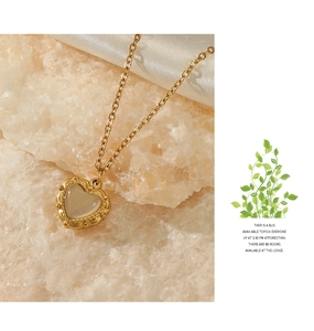 Detail of 14K gold-plated heart necklace with opal inlay and vintage bead edging