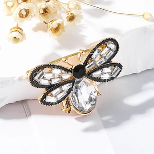 Macro shot of bee brooch with gold plating, sparkling rhinestones and crystal belly detail