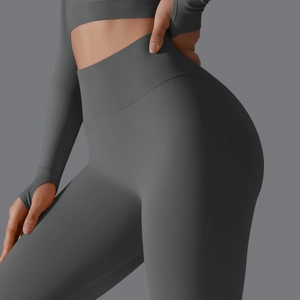 Detailed texture of seamless dark gray high-waisted yoga pants and long sleeve crop top set
