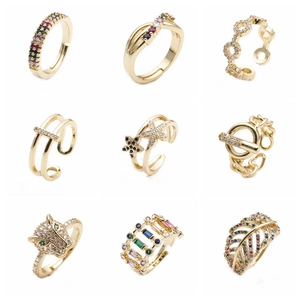 Set of nine adjustable gold-colored rings featuring colorful cubic zirconia designs