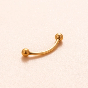 Detailed view of G23 titanium gold curved barbell with internal threading and polished beads