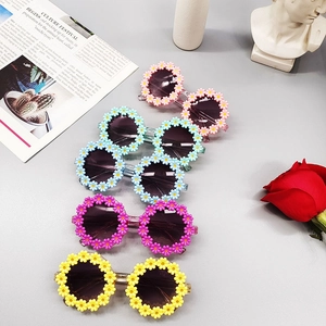 Detailed view of colorful daisy flower kids sunglasses in pink blue purple and yellow