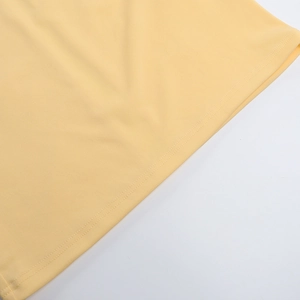Detail of the high-quality double-needle hem stitching on a cream summer maxi dress