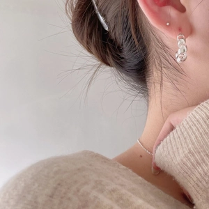 Minimalist 925 sterling silver C-shaped twisted hoop earrings on female model